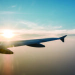 airplane wing and sunset on blue sky