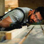carpenter-cutting-mdf-board-inside-workshop